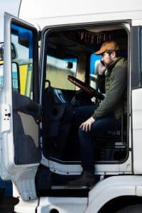 full-shot-man-sitting-truck_23-2149426508